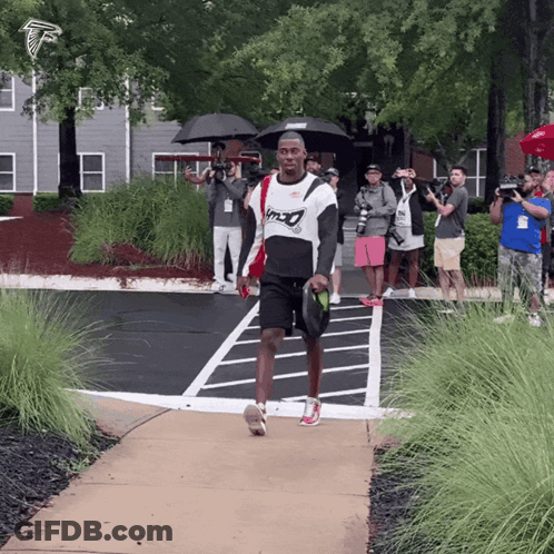 Man Walking In Falcons Shirt GIF