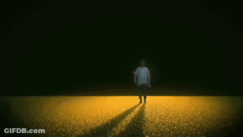 Man Walking In Field With Fire Explosion GIF