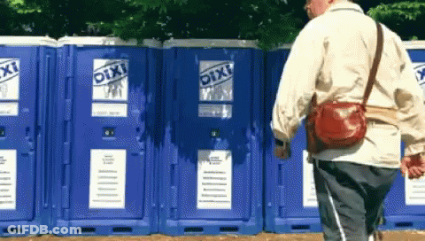 Man Walking In Front Of Blue Pixi Toilets GIF