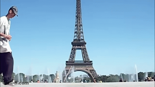 Man Walking In Front Of Eiffel Tower GIF