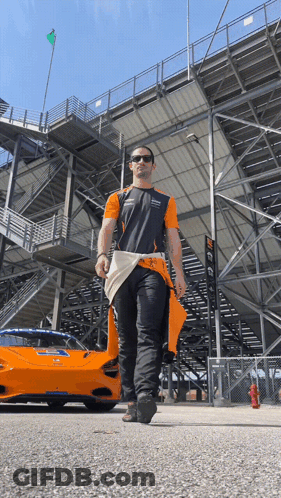 Man Walking In Front Of McLaren Race Car GIF