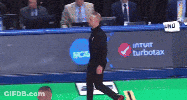 Man Walking In Front Of NCAA Banner GIF