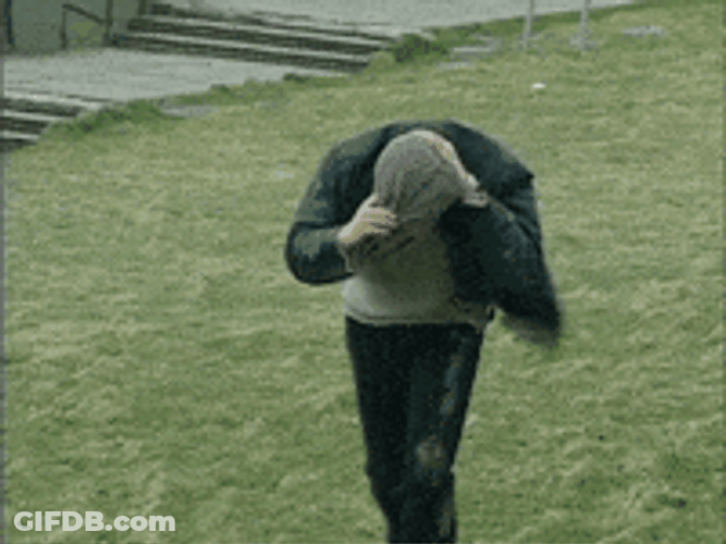 Man Walking In Strong Wind GIF