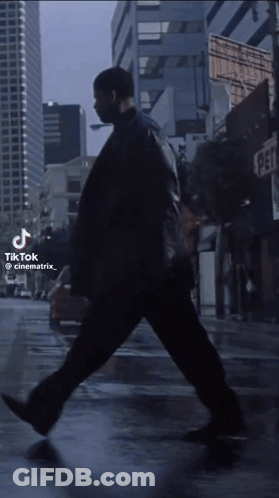 Man Walking On City Street With TikTok Watermark GIF