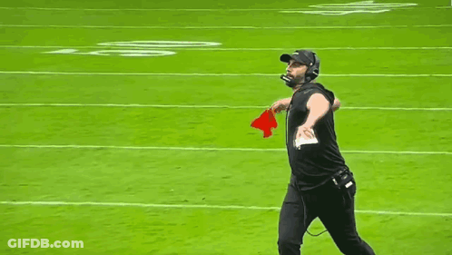 Man Walking On Football Field With Microphone And Helmet GIF