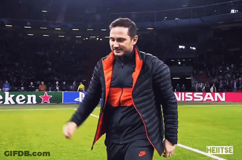 Man Walking On Soccer Field In Front Of Heineken Nissan Sign GIF