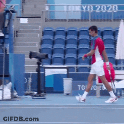 Man Walking On Tennis Court With Tokyo 2020 GIF