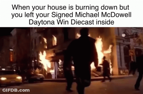 Man Walking Past Burning Building GIF
