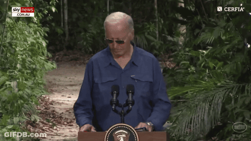 Man Walking Past Podium With Sky News Logo GIF