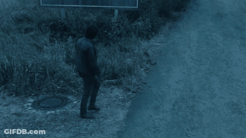 Man Walking Past Welcome To Silent Hill Sign GIF