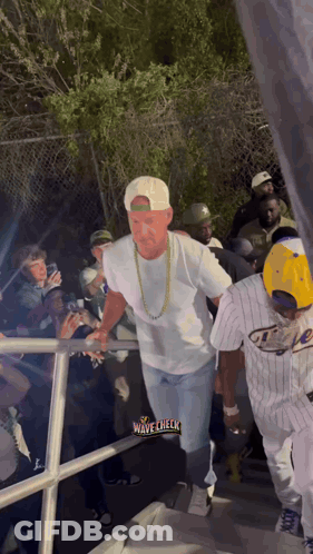 Man Walking Through Crowd Wave Check GIF
