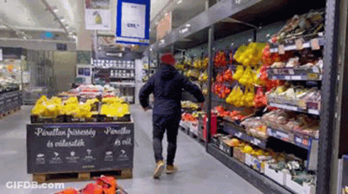 Man Walking Through Fruit And Vegetable Aisle GIF