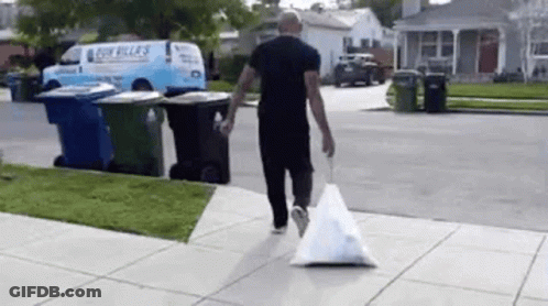 Man Walking With Trash Bag GIF