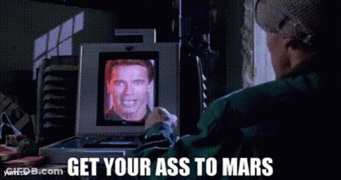 Man Watching Arnold Schwarzenegger On Computer Screen GIF
