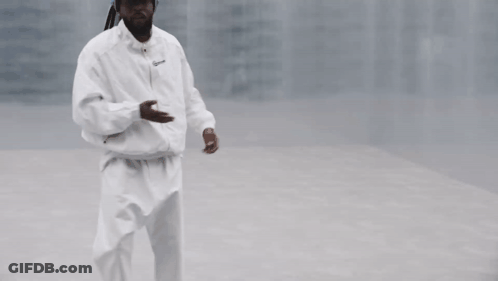 Man Waving In White Jacket And Pants GIF