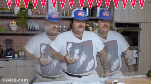 Man Wearing A.C.H. Shirt Standing In Kitchen GIF
