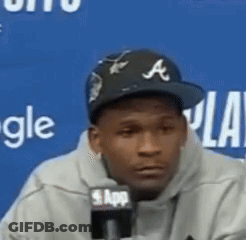 Man Wearing Baseball Cap Talking Into Microphone GIF