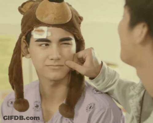 Man Wearing Bear Hat With Bandage On Head GIF