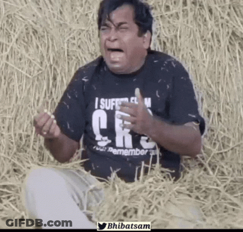 Man Wearing Black Shirt Saying I Suffer From CRS Sitting In Hay GIF
