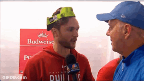 Man Wearing Budweiser Hat Interviewed GIF