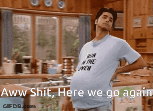 Man Wearing Bun In The Oven Shirt In Kitchen GIF
