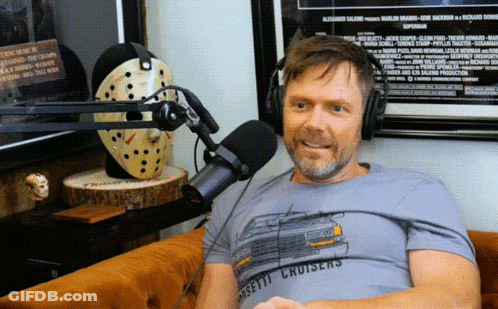 Man Wearing Cassette Cruisers T-Shirt Sitting At Microphone GIF