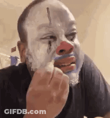 Man Wearing Clown Mask Shaving GIF