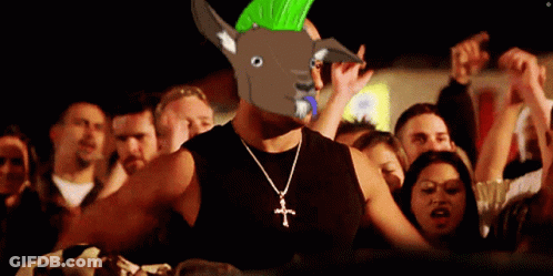 Man Wearing Cross Necklace And Mohawk Stands In Front Of Crowd GIF