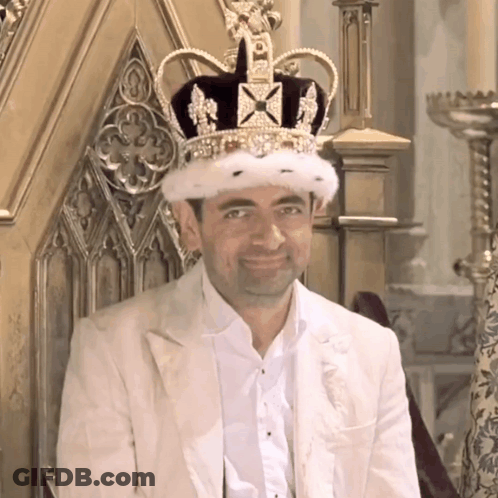 Man Wearing Crown Sitting On Throne Smiling GIF
