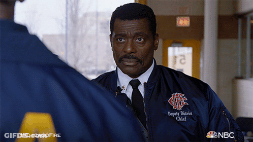 Man Wearing Deputy District Chief Jacket Talking To Another Man GIF