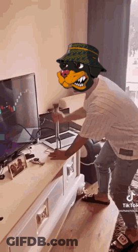 Man Wearing Dog Mask Standing In Front Of Television GIF