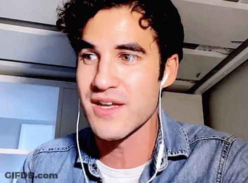 Man Wearing Ear Buds And Denim Shirt GIF