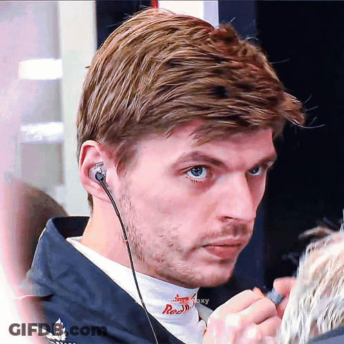 Man Wearing Earbuds With Red On Shirt GIF