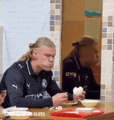 Man Wearing Etihad Shirt Eating GIF