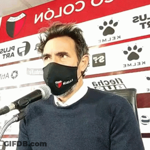 Man Wearing Face Mask At Microphone GIF