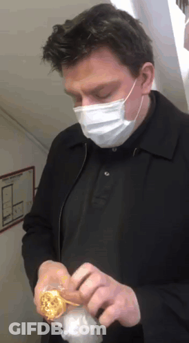 Man Wearing Face Mask Holding Donut GIF