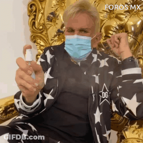 Man Wearing Face Mask Holding Spray Bottle GIF