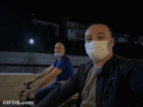 Man Wearing Face Mask Riding Bike GIF