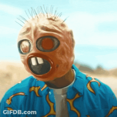 Man Wearing Gas Mask And Blue Shirt With Flames On Sleeves GIF