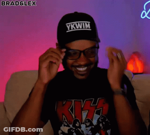 Man Wearing Glasses And Baseball Cap Sitting On Couch GIF