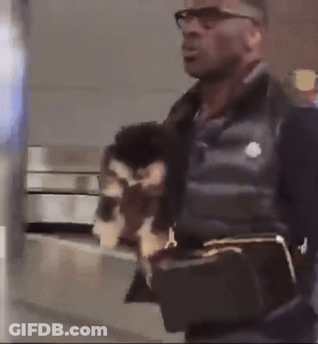 Man Wearing Glasses And Black Vest Holding Purse GIF