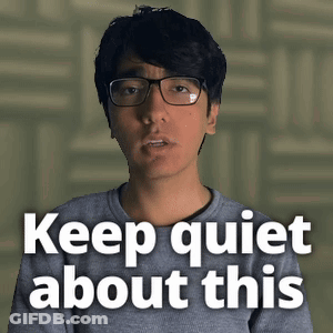 Man Wearing Glasses And Grey Shirt Says Keep Quiet GIF