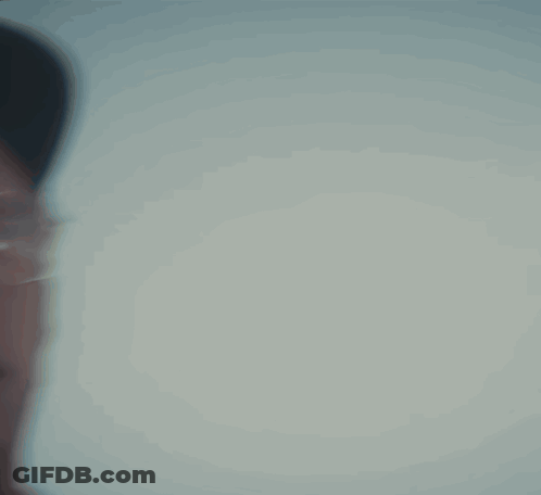 Man Wearing Glasses And Hat Looking At Camera GIF