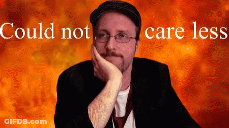 Man Wearing Glasses And Hat With Could Not Care Less Behind Him GIF