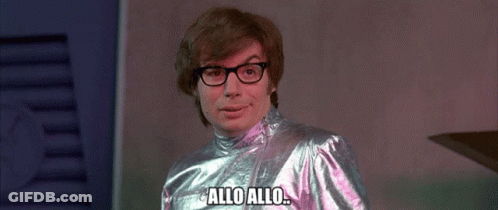 Man Wearing Glasses And Metallic Outfit Says Allo Allo GIF