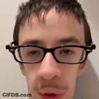 Man Wearing Glasses And Mustache Looking At Camera GIF