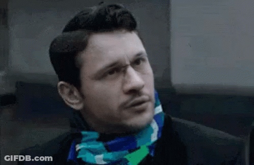 Man Wearing Glasses And Scarf Making Funny Face GIF