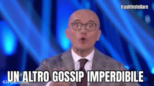 Man Wearing Glasses And Suit Says Un Altro Gossip Imperdibile GIF