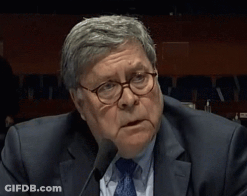 Man Wearing Glasses And Suit Sitting At Microphone GIF