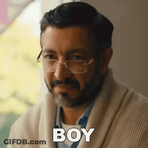 Man Wearing Glasses And Sweater Says Boy GIF